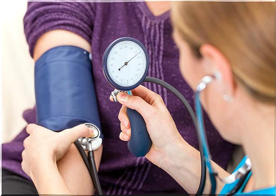 A doctor taking blood pressure.